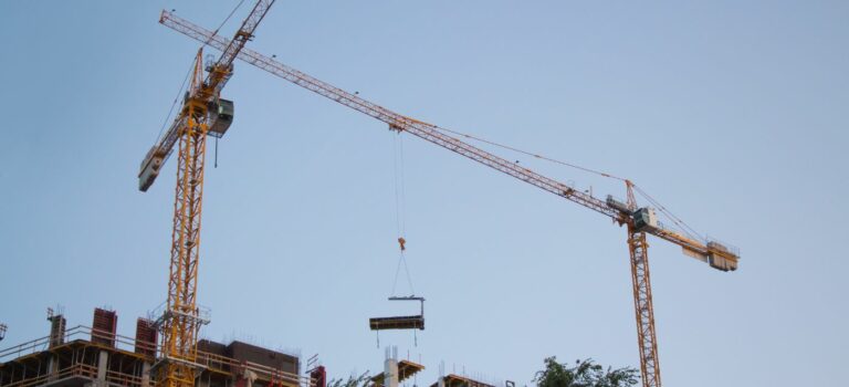 Des grues sur un chantier pour illustrer les permis de construire