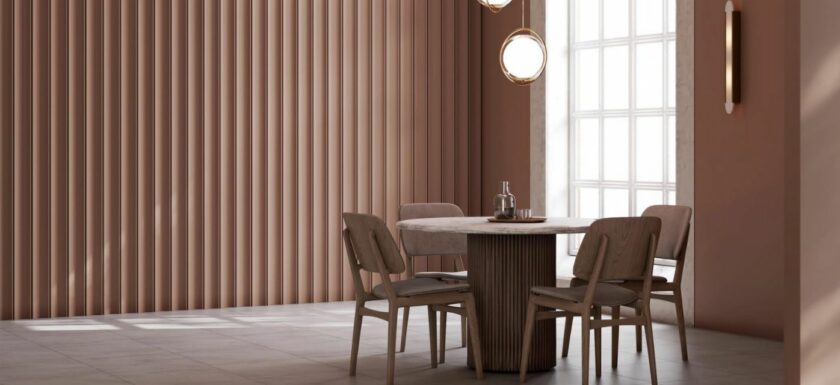 Salle a manger contemporaine aux murs couleur Mocha Mousse, avec table ronde en bois clair et chaises assorties, baignee de lumiere naturelle.