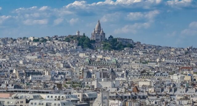 Vue aerienne de Paris et du Sacre-Cœur, symbole de la politique du logement et de l’encadrement des loyers.