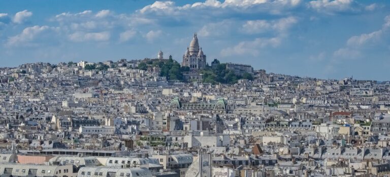 Vue aerienne de Paris et du Sacre-Cœur, symbole de la politique du logement et de l’encadrement des loyers.