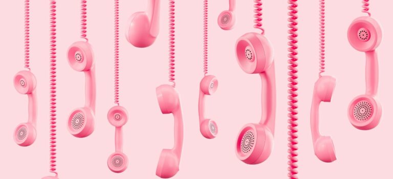 Plusieurs combines telephoniques roses suspendus sur fond rose clair