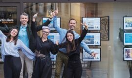 L’équipe d’une agence immobilière Côté Particuliers devant sa vitrine