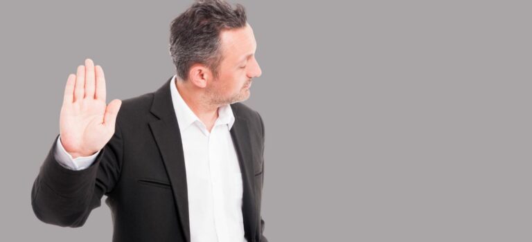 Homme levant la main pour signifier un refus